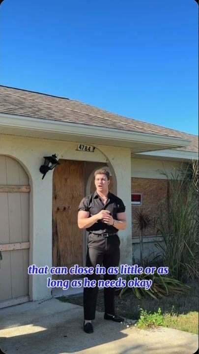 David Melman standing outside a boarded up Gulf Coast house the company purchased